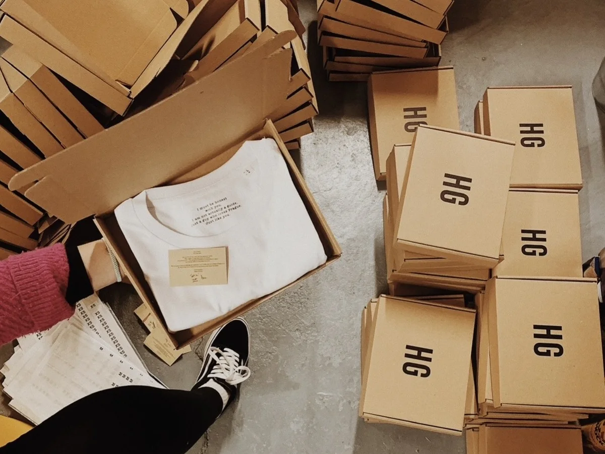 Packing T-shirts into printed boxes with an insert card