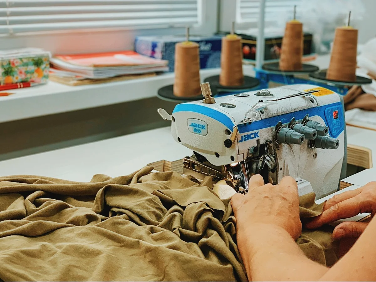 Sewing a T-shirt on an overlocker in our workshop